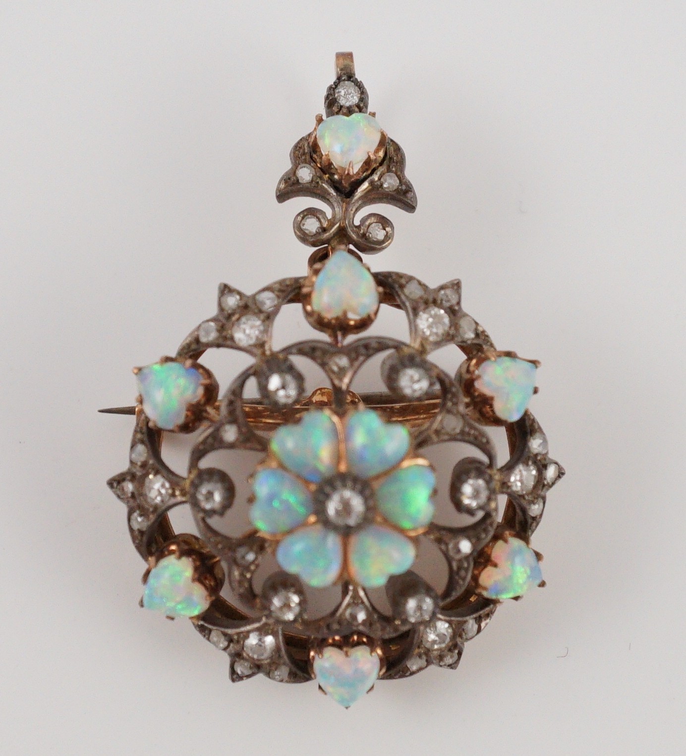 A late Victorian gold silver and diamond circular cluster pendant brooch, 3.5cm, gross 17.5 grams